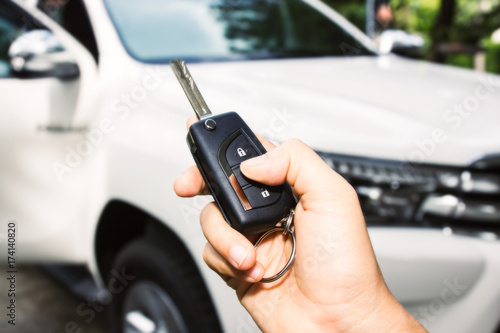 Woman hand holding a car key remote
