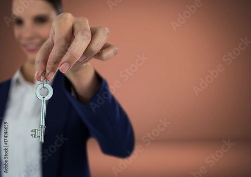 Woman holding key in front of Vignette
