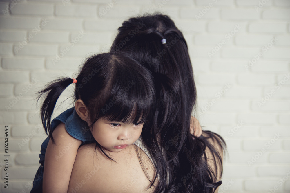 Fototapeta premium Mother holding her crying Daughter.