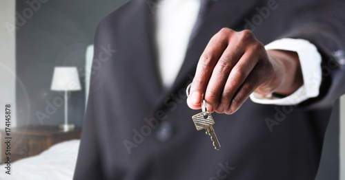 Hand Holding key in bedroom