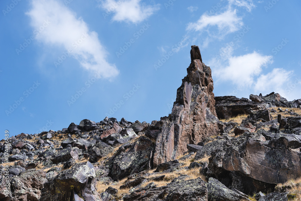 Fototapeta premium High-mountainous sharp rocks against the blue sky and white clouds. Caucasus
