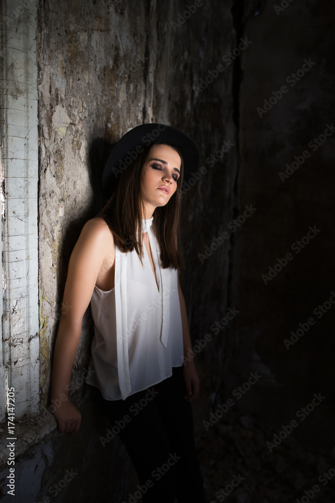 A girl in a white blouse, with tare destroyed building. Helouin.