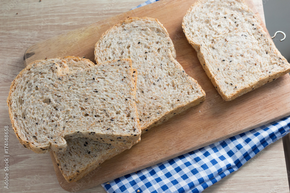 Top view of sliced wholegrain bread on a wooden table. Top view of sliced wholegrain bread on a wooden table.