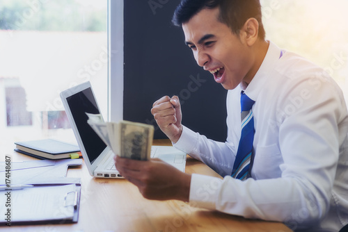 Young business people show joy after successful work. And get big bonuses.