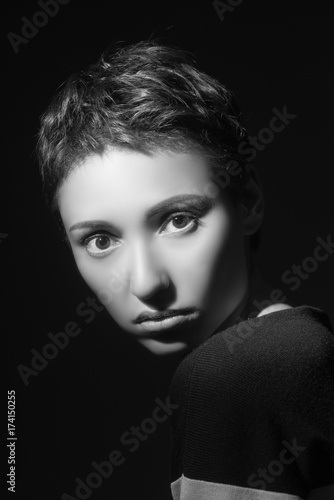 portrait of beautiful sensual woman looking at camera on dark background 
