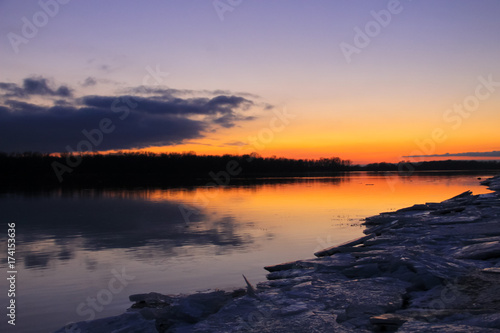 Bright sunset over a river Dnieper on winter © olyasolodenko