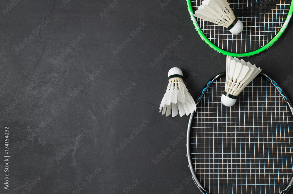 Shuttlecocks and badminton racket on black background. - obrazy, fototapety, plakaty 