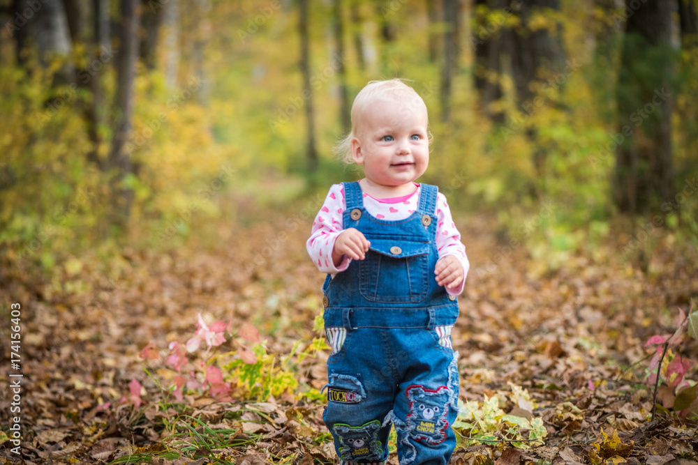 happy baby girl laughing and playing in the autumn on the forest happy baby girl laughing and playing in the autumn on the forest