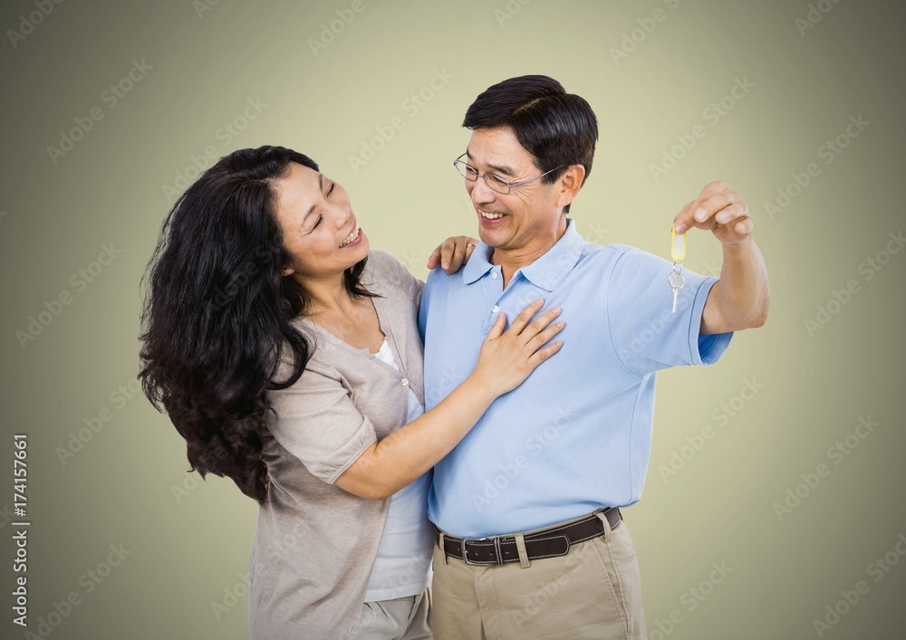 Couple Holding key in front of vignette Couple Holding key in front of vignette