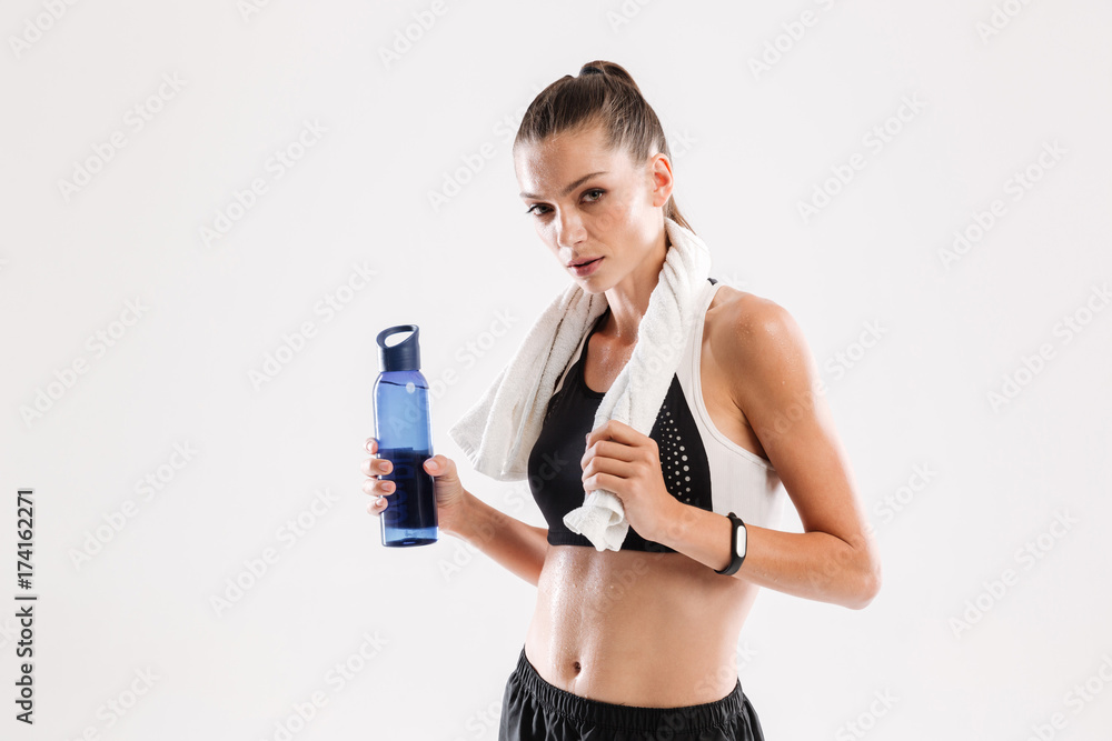 Tired sweaty fitness woman with towel on her neck Tired sweaty fitness woman with towel on her neck