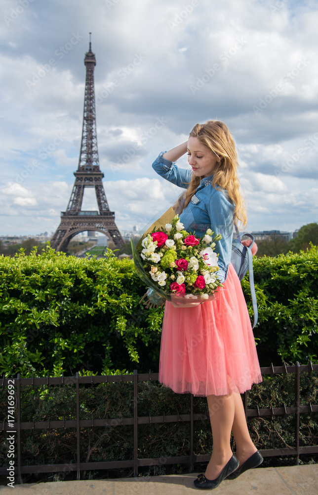 Girl in Paris with big bouquet of flowers