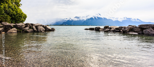 Panoramic view of Lake Geneva with swiss alps background, one of Switzerland's most cruised lakes in Europe, Vaud, Switzerland. Design for background, backdrop, template, wallpaper, screen, space.