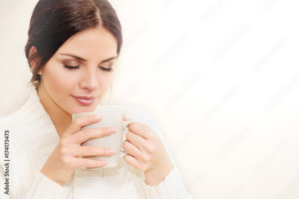 Beautiful young woman enjoying a cup of coffee Beautiful young woman enjoying a cup of coffee