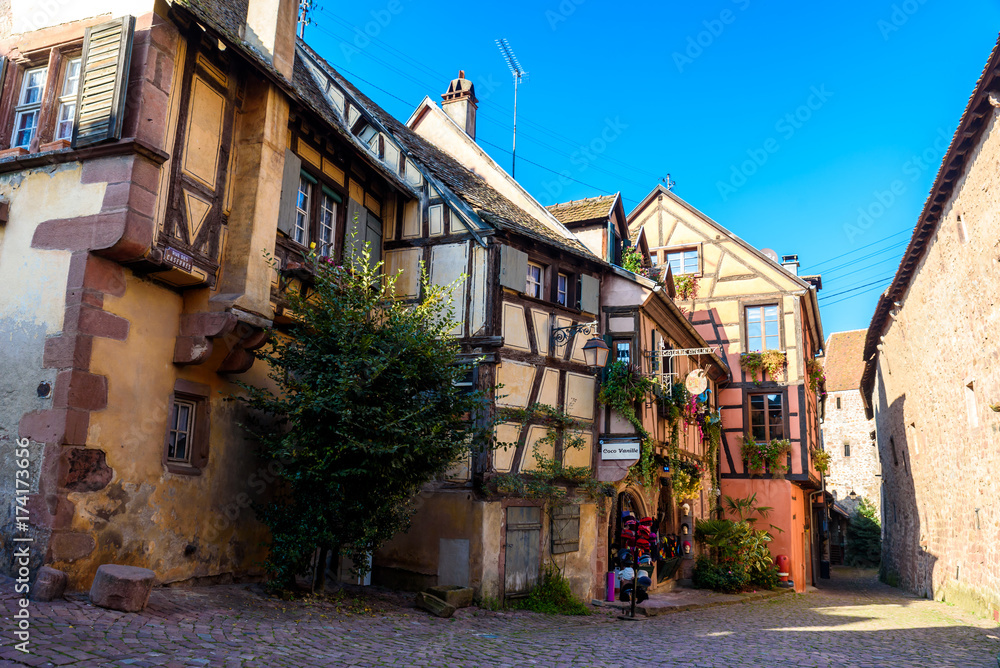 Beautiful village Riquewihr with historic buildings and colorful houses in Alsace of France - Famous vine route