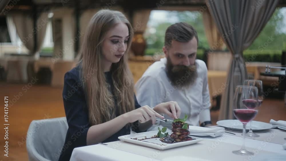 A girl at a restaurant trying a foie gras A girl at a restaurant trying a foie gras