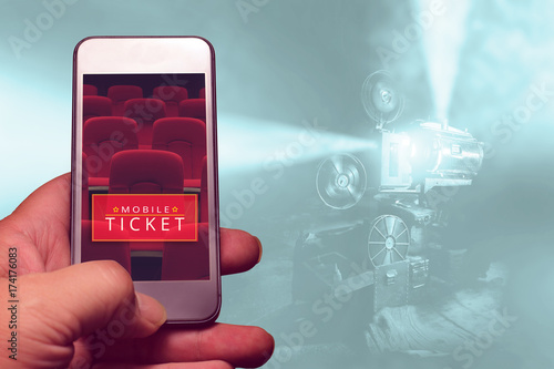 hand holding smartphone for reserved movie ticket. online ticket buying.