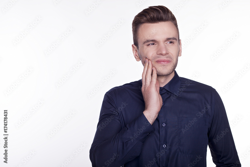 Toothache. Frustrated young man touching his cheek isolated on white background. Toothache. Frustrated young man touching his cheek isolated on white background.