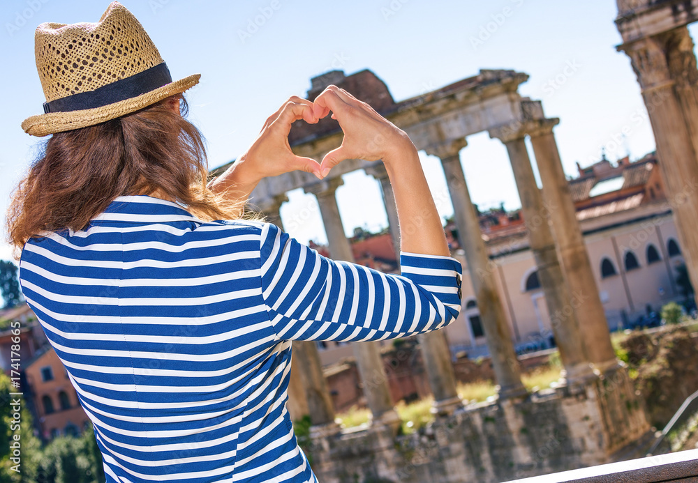 trendy tourist woman in Rome, Italy showing heart shaped hands