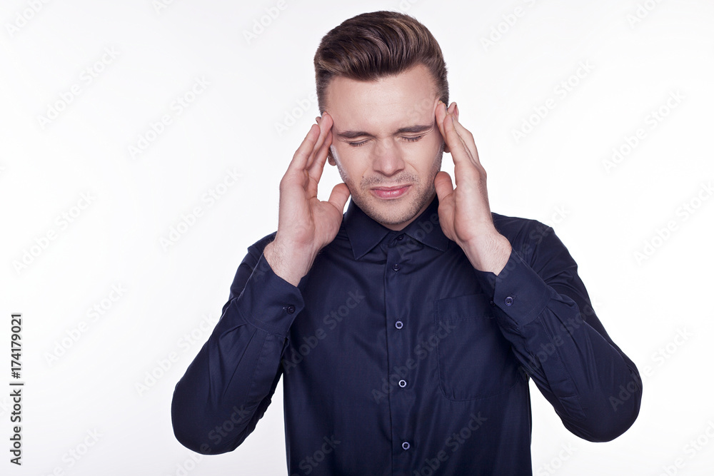 Feeling bad. Close-up of frustrated young handsome man with headache isolated on white background. Feeling bad. Close-up of frustrated young handsome man with headache isolated on white background.
