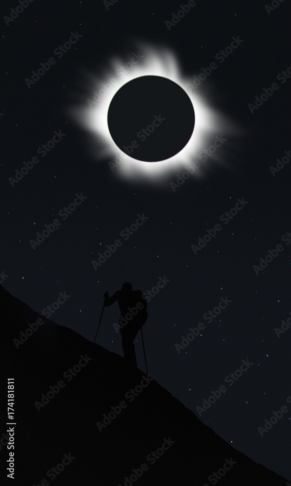 Man watching total eclipse during hiking 