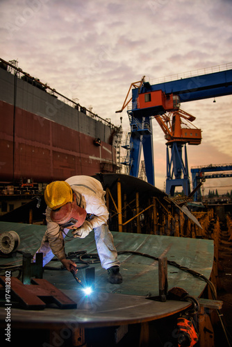 A welder at a shipyard