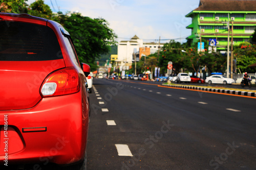  red  car parking lot on daytime © rathchapon