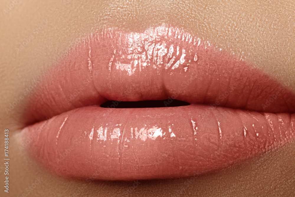 Moisturizing lip balm, lipstick. Close-up of a beautiful sexy wet lips. Full lips with gloss makeup. Filler Injections Moisturizing lip balm, lipstick. Close-up of a beautiful sexy wet lips. Full lips with gloss makeup. Filler Injections