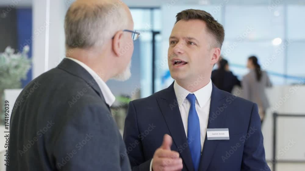 Friendly bank workers talking to customers & offering financial advice Friendly bank workers talking to customers & offering financial advice