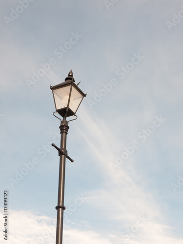 black outside street lamp with blue and cloud sky