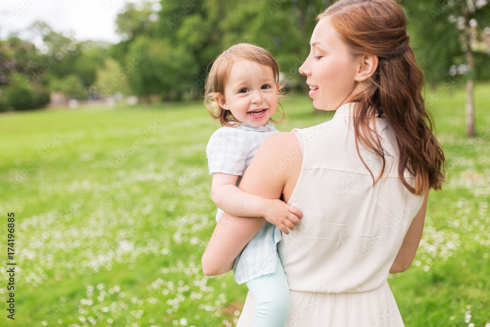 happy mother holding baby girl at summer park happy mother holding baby girl at summer park
