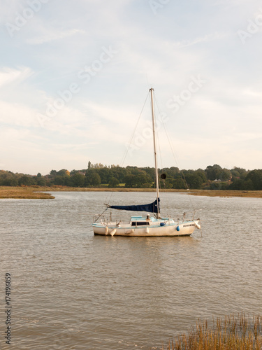 single private boat moored in river high tide landscape scene