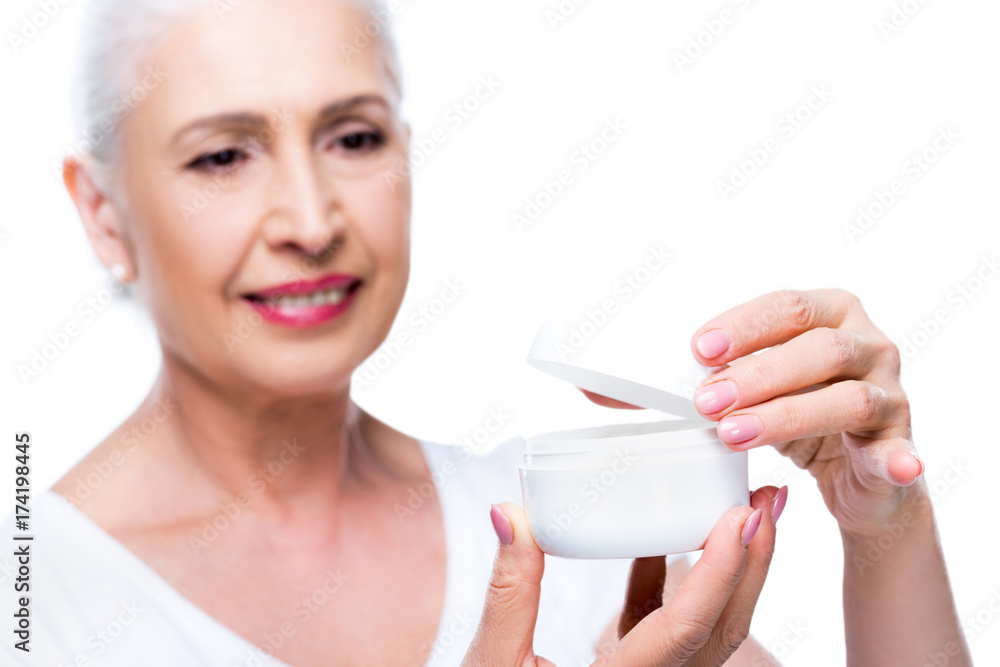 senior woman with anti-wrinkle cream senior woman with anti-wrinkle cream