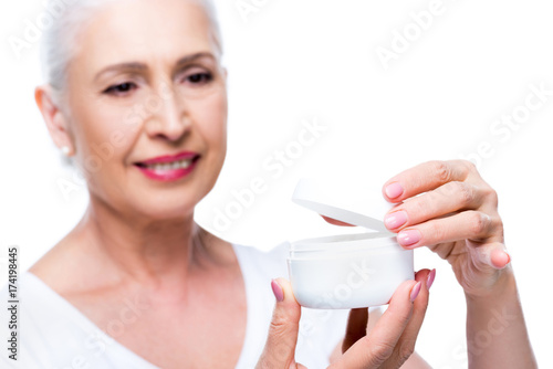 senior woman with anti-wrinkle cream