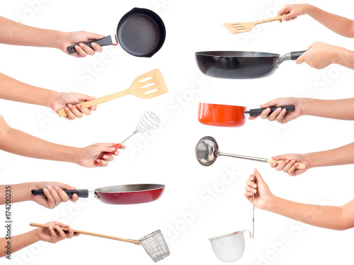 Chef's hands holding kitchen utensils/many equipments for food isolated on white background