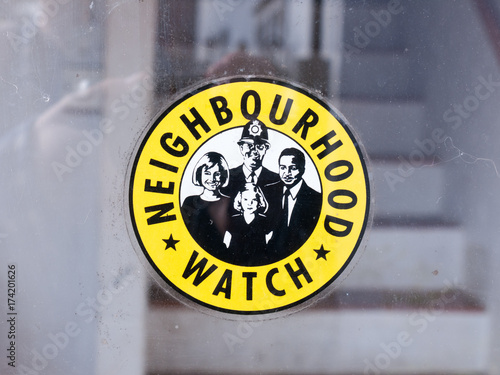 neighbourhood watch sign yellow and black police crime outside window