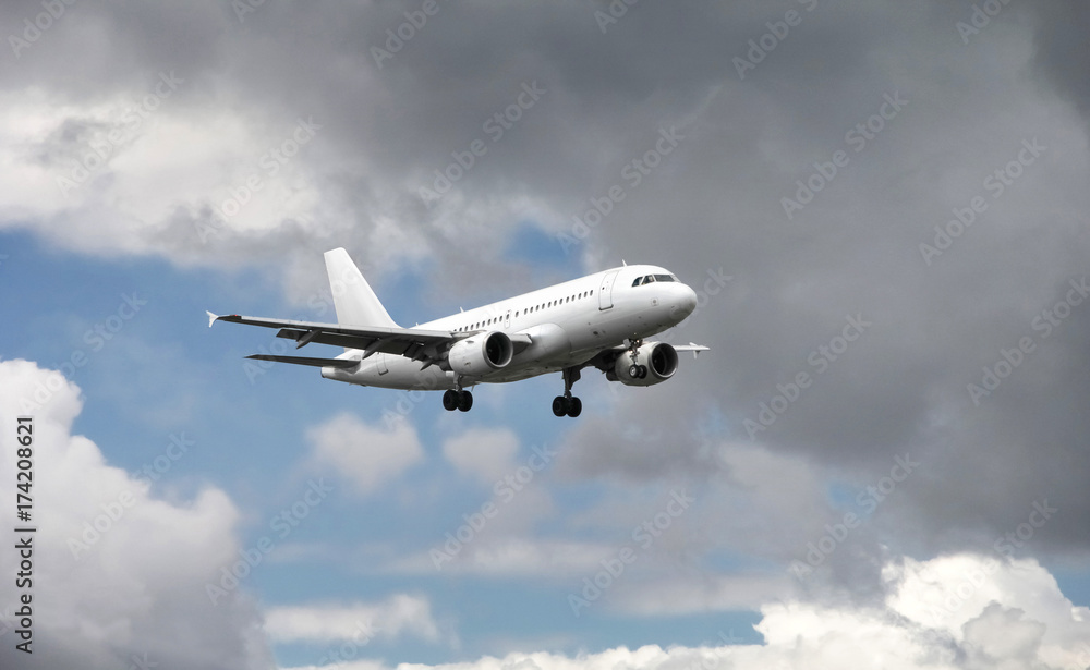 Airplane approaching at the airport, with cloudy background