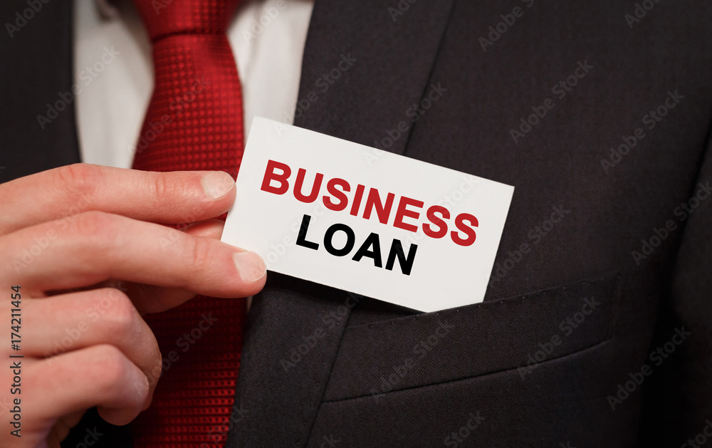 Businessman putting a card with text Business Loan in the pocket Businessman putting a card with text Business Loan in the pocket