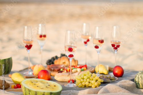 Group of friends enjoying with champagne at the Beach