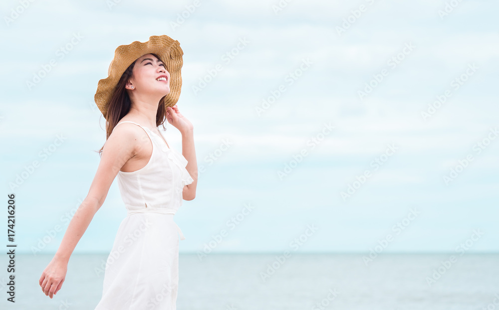 Asian beautiful woman breathing up for fresh air feel relaxing and happy over sea/beach and sky background Asian beautiful woman breathing up for fresh air feel relaxing and happy over sea/beach and sky background