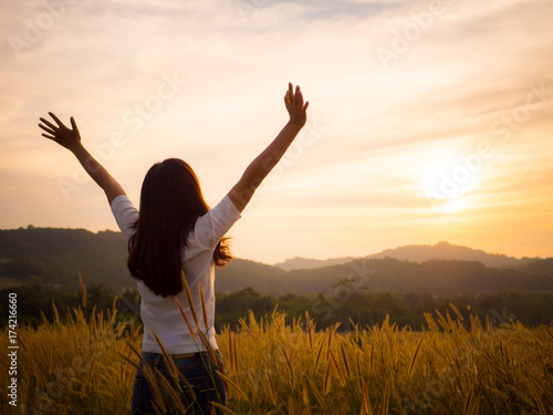 Silhouette woman rising hands and face to sunlight in the morning with freedom  fresh  soft feeling.