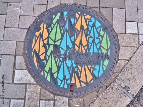 Manhole cover of Hiroshima engraved with origami paper cranes. The one thousand origami cranes were through the story of Sadako Sasaki, victims of nuclear warfare.