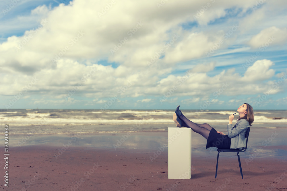 Business woman is dreaming on the beach sitting on a chair.