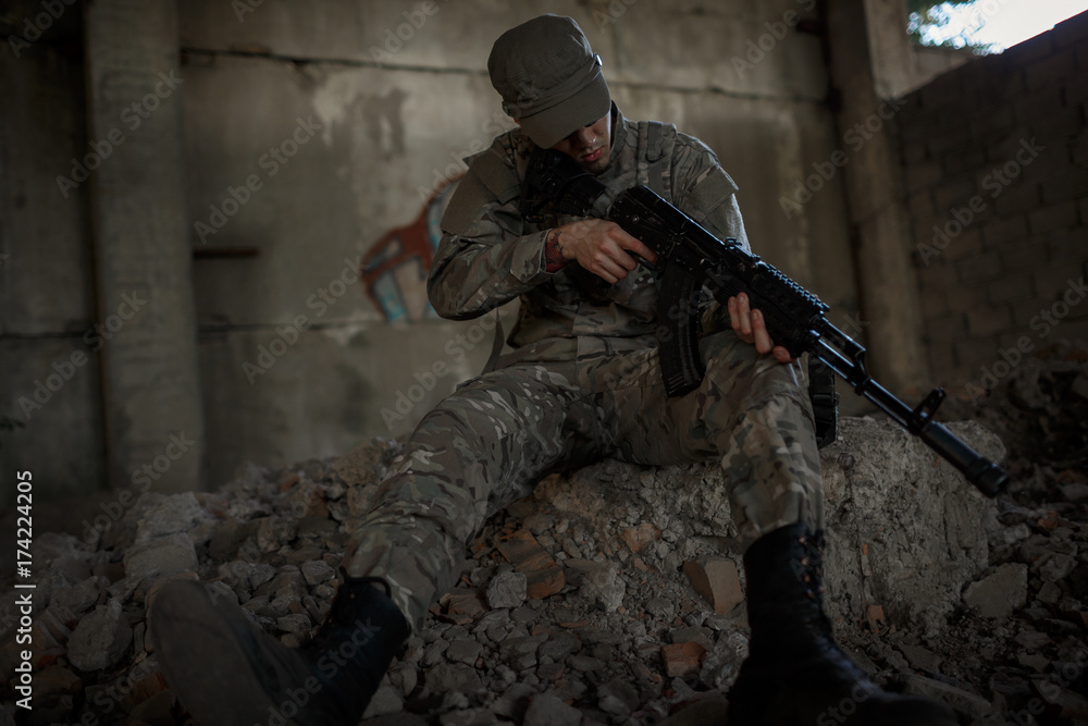 a soldier in uniform and an automatic machine in his hands a soldier in uniform and an automatic machine in his hands
