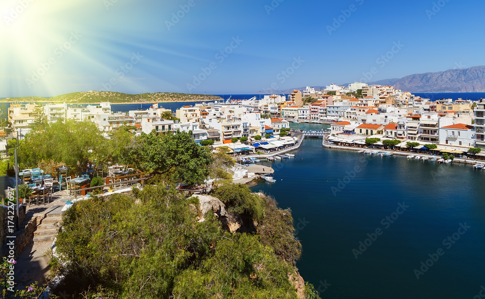 The lake Voulismeni in Agios Nikolaos, picturesque coastal town with colorful buildings around the port in the eastern part of the island Crete, Greece