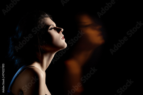 sensual dreaming woman in enjoyment at dark