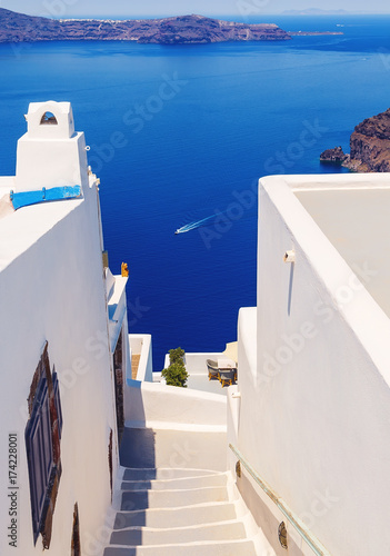 White architecture with steps leading down to the sea on Santorini island, Greece. Beautiful landscape with sea view.