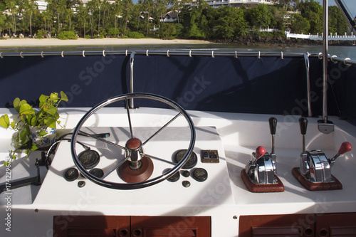 Steering wheel and control panel on yacht.