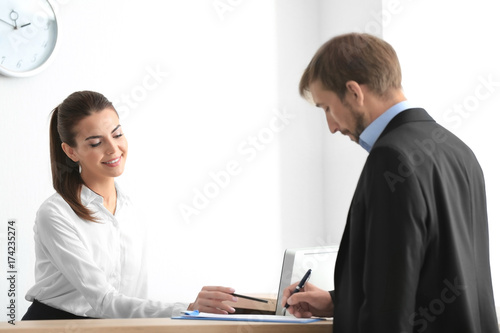 Wallpaper Mural Young female receptionist meeting client in office Torontodigital.ca