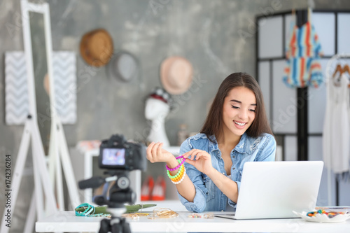 Young female blogger with a...