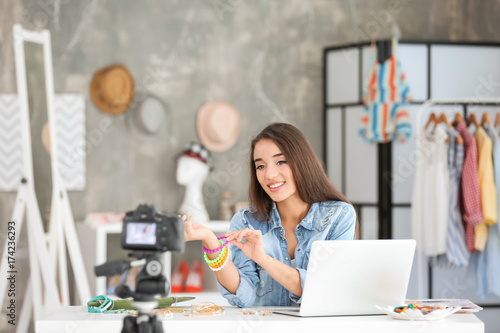 Young female blogger with a...
